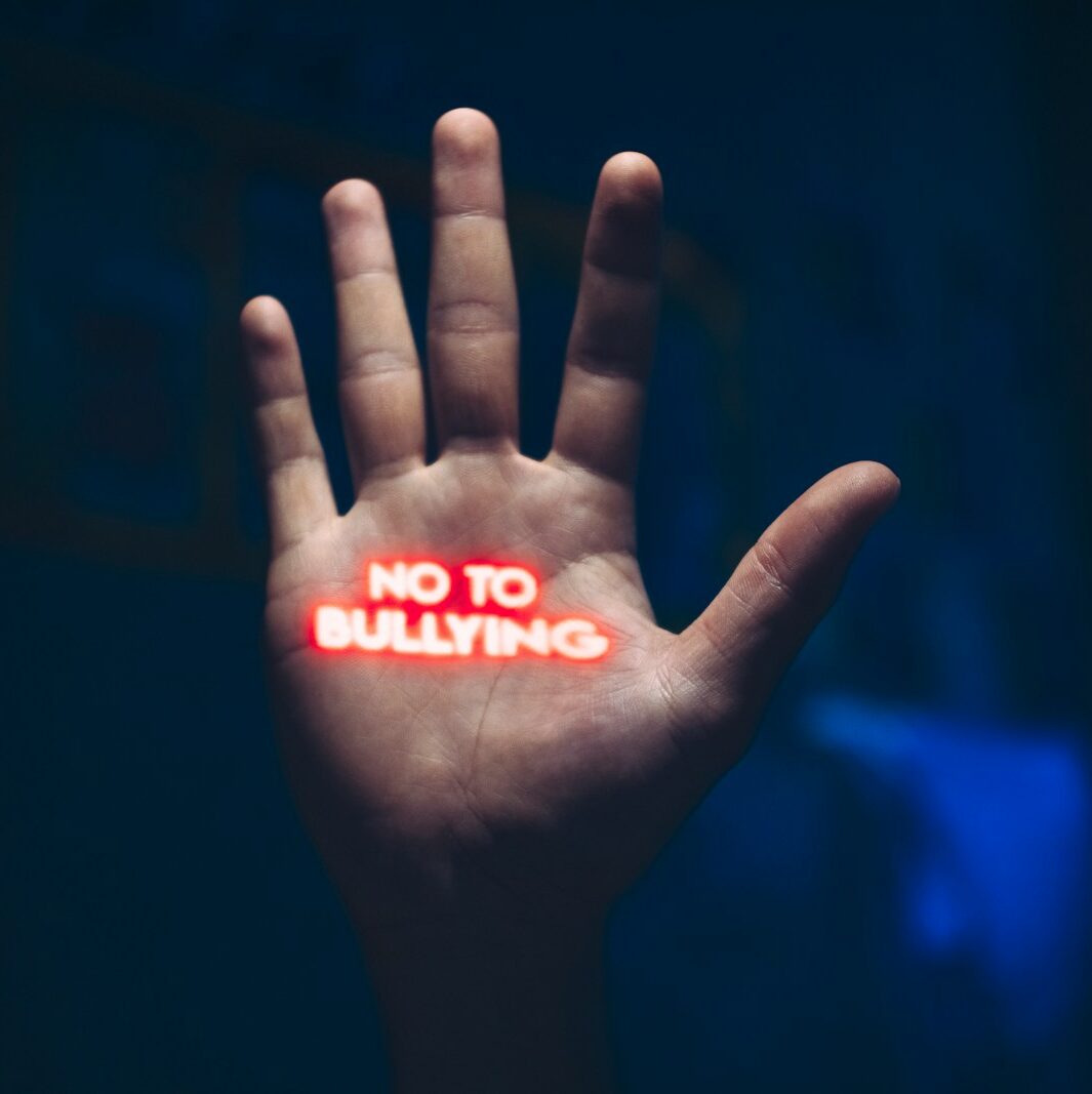 a hand with the word no to bullying written on it